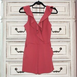 pink ruffled romper with pockets